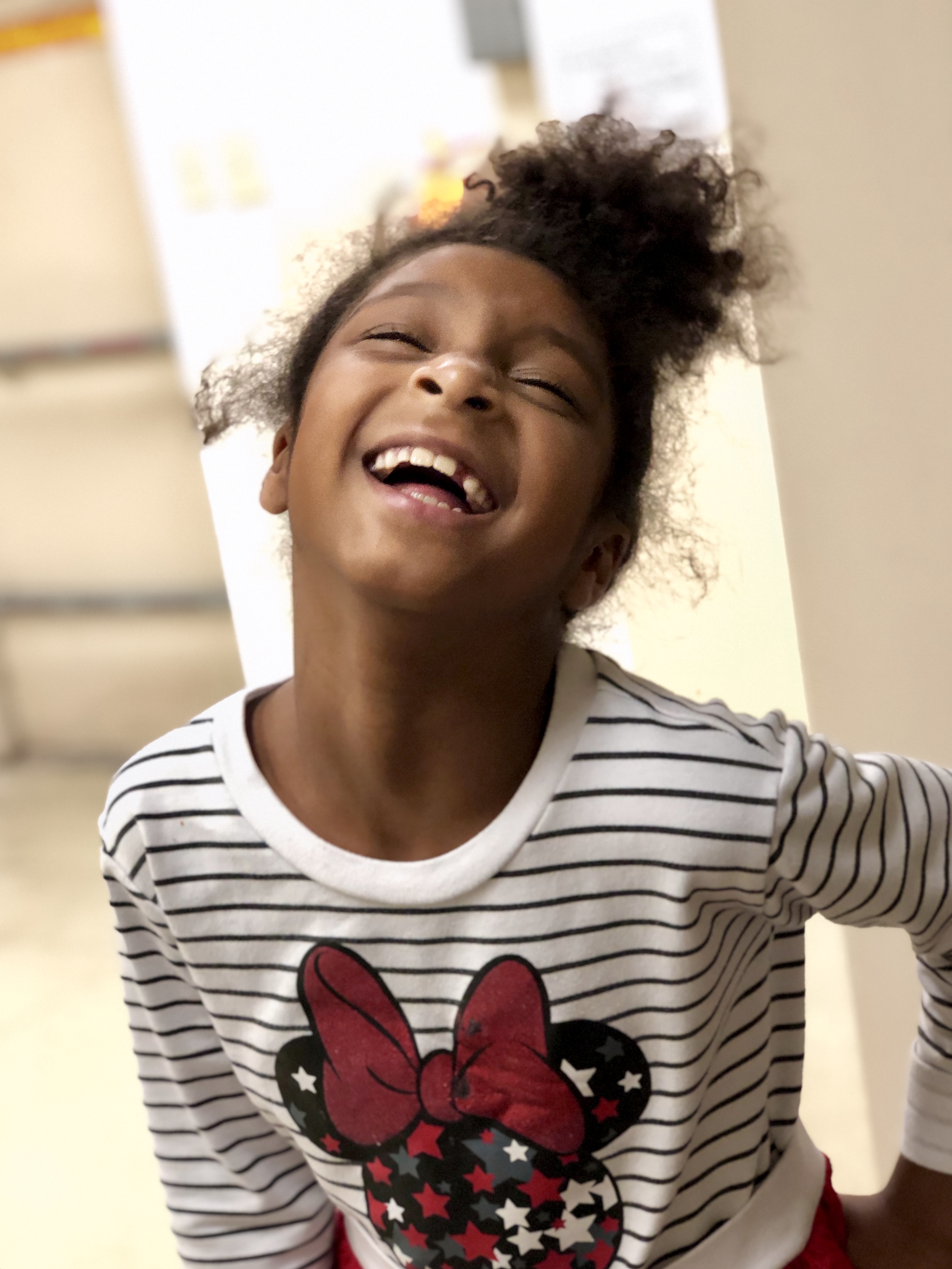 little girl posing while laughing