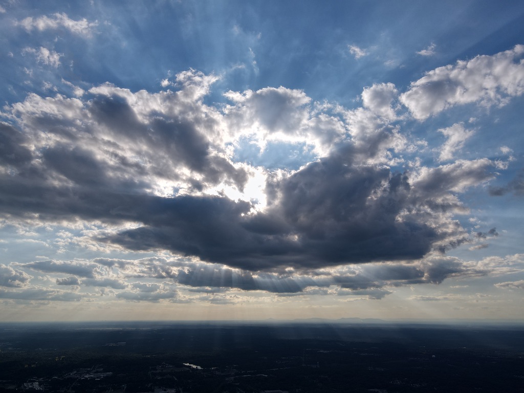 View of the sky with clouds and sun rays